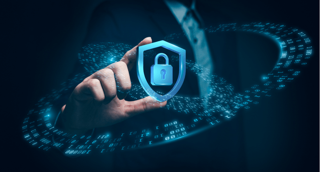 Business professional's hand touches a glowing shield with a lock, symbolizing cybersecurity and data protection.